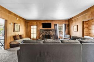 a living room with a couch and a fireplace at Green Cabin in Big Bear Lake 3 bdr Pets Friendly in Big Bear City