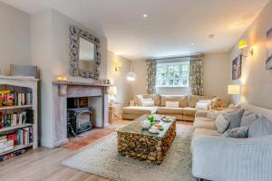 a living room with a couch and a fireplace at Dune House in Brancaster