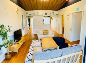 a living room with a couch and a table at I will meet Hyakuna, - Vacation STAY 33599v in Nanjo