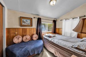 a bedroom with two beds and a window at Green Cabin in Big Bear Lake 3 bdr Pets Friendly in Big Bear City