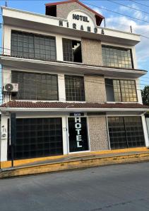 a hotel building with a sign on the front of it at Hotel Miranda in La Concepción