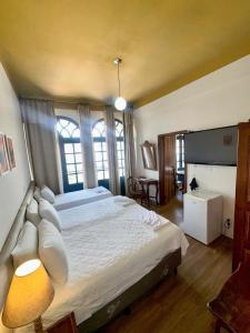 a bedroom with a large bed and a window at Hotel Lenheiros in São João del Rei +48 photos