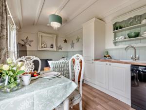 a kitchen with a table with a bowl of fruit on it at 1 Bed in Boscastle 95316 in Camelford
