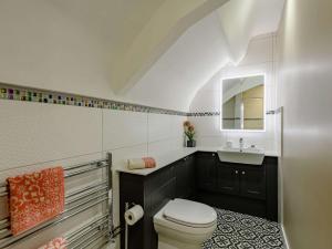 a white bathroom with a toilet and a sink at 1 Bed in Wool 88099 in Wool