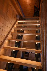 an overhead view of a wooden staircase in a cabin at A Frame Vila sa Saunom Jakuzi kadom i toplim bazenom in Koraćica +37 photos