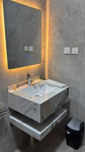 a bathroom with a large marble sink and a mirror at Rest home in Tabuk +39 photos