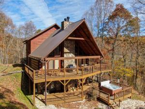 a cabin in the woods with a large deck at Ambleside in Vilas