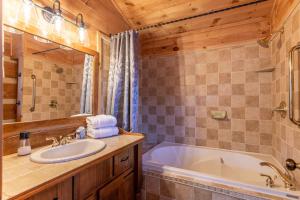 a bathroom with a tub and a sink at Lakeview in Vilas +60 photos