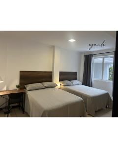 Postel nebo postele na pokoji v ubytování Agenda Hotel
