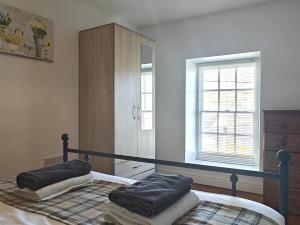 a bedroom with a bed with two pillows on it at 3 Bed in Aberaeron 95971 in Aberaeron +17 photos