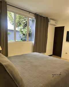 Postel nebo postele na pokoji v ubytování Agenda Hotel