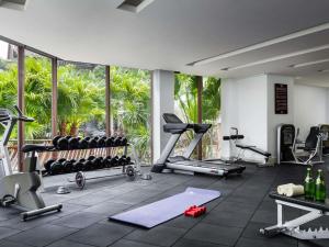 a gym with fitness equipment and a large window at Pullman Sanya Yalong Bay Villas & Resort in Sanya