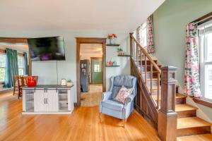 a living room with a staircase and a chair at 1 Mi to Dtwn Binghamton Pet-Friendly Home with Deck in Binghamton