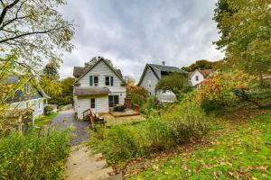 a white house in a yard with houses at 1 Mi to Dtwn Binghamton Pet-Friendly Home with Deck in Binghamton