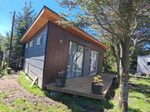 a tiny house with a porch and a deck at Tiny House Ruta 215 in Osorno