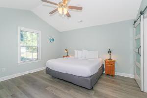 a bedroom with a bed and a ceiling fan at Coastal Pet Friendly Getaway in Murrels Inlet! Perfect for 8 Guests! in Myrtle Beach