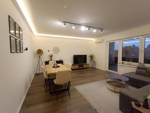 a living room with a table and a couch at PanoramaLoft Warendorf in Warendorf