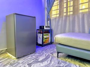 a bedroom with a bed and a table and a window at Cozy Corners in Iseri-Oke