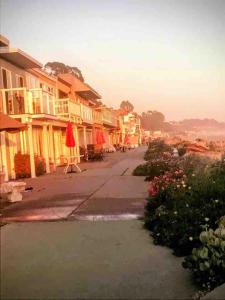 a street with a row of houses and flowers at Aptos Beach Retreat Hot Tub & 5 Min Walk to Sand in Rio Del Mar