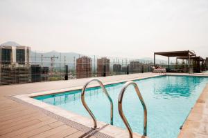 a swimming pool on top of a building at Riesco Suites by Andes STR in Santiago +40 photos