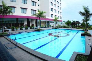 a large swimming pool in front of a building at Asialink Premier hotel in Karawang