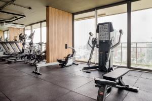 a gym with several treadmills and machines in a building at Riesco Suites by Andes STR in Santiago
