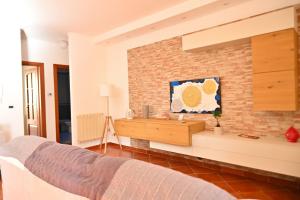 a bedroom with a bed and a brick wall at Dimora Lucci Marini in Taranto