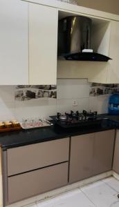 a kitchen with a black counter top with a stove at Flat in wah cantt in Wāh