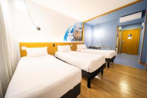 Ένα ή περισσότερα κρεβάτια σε δωμάτιο στο Hotel Euro Suite Curitiba Batel By Nacional Inn