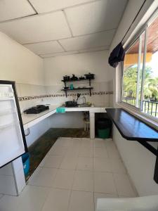 a kitchen with a sink and a window at Apartamentos Coveñas TII in Coveñas +35 photos