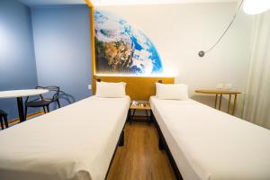 Ένα ή περισσότερα κρεβάτια σε δωμάτιο στο Hotel Euro Suite Curitiba Batel By Nacional Inn