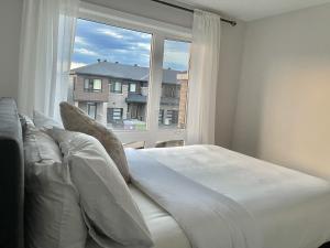 a bedroom with a bed and a large window at Beautiful room in Ottawa with Private bathroom in Ottawa