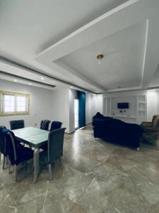 a living room with a table and a couch at Vrtn hotel in Amman