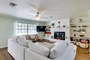 a living room with a white couch and a fireplace at Bring Your Boat! Canal-Front Tavares Home with Dock in Tavares