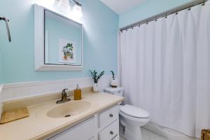 a white bathroom with a sink and a toilet at Bring Your Boat! Canal-Front Tavares Home with Dock in Tavares +16 photos