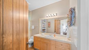 a bathroom with a sink and a mirror at Vineyard Estate w Pool Spa Bocce Ball Mins to Wineries Park Lawndale Road by AvantStay in Lawndale +44 photos