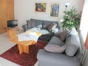 a living room with a couch and a table at Holiday apartment with 2 bedrooms in Wursterheide