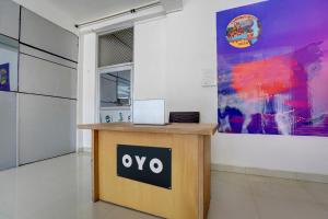 a desk in a room with a laptop on it at SPOT ON New Hamsafar in Jhūsi