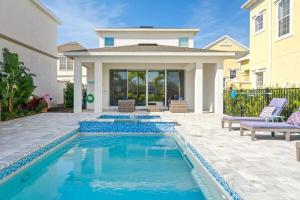 a swimming pool in the backyard of a house at LC517T The Chic Abode at Liberty Bluff in Kissimmee