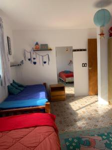 a bedroom with two beds and a door to another room at Estrella de Mar in La Paloma