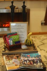 a table with a book and a banana and magazines at SEAS THE DAY house hot tub pet friendly bbq location location location in Gibsons