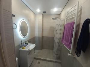a white bathroom with a sink and a shower at Rent house Vanadzor centre in Vanadzor