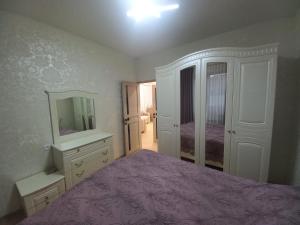 a bedroom with a bed and a dresser and a mirror at Rent house Vanadzor centre in Vanadzor
