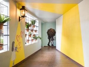 a hallway with a person holding an umbrella at Aparthotel Adagio Paris Montmartre in Paris