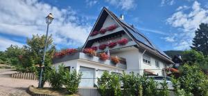 a white house with flower boxes on it at Renatas Ferienwohnung ISABEL in Sasbachwalden +52 photos