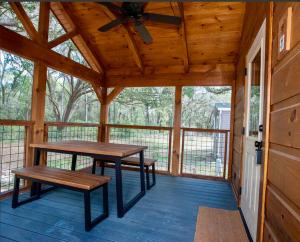 オカラにあるLuxury Cabin 12の2つのベンチと天井ファンを備えた網戸付きポーチ
