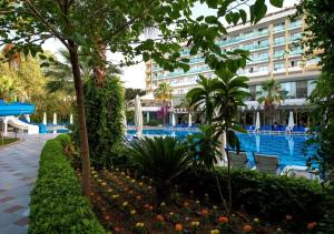 a resort with a swimming pool and a building at Sentido Lycus Beach Hotel in Alanya