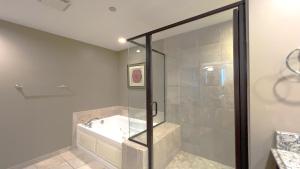a bathroom with a shower with a tub and a sink at Mar Vista Grande - 806 in Myrtle Beach +36 photos