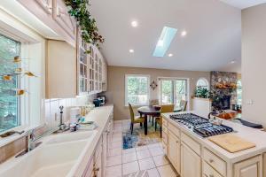a kitchen with a sink and a stove at Betsie Woods in Thompsonville +39 photos