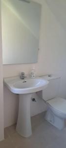 a bathroom with a white sink and a toilet at Villa Bobal in Requena